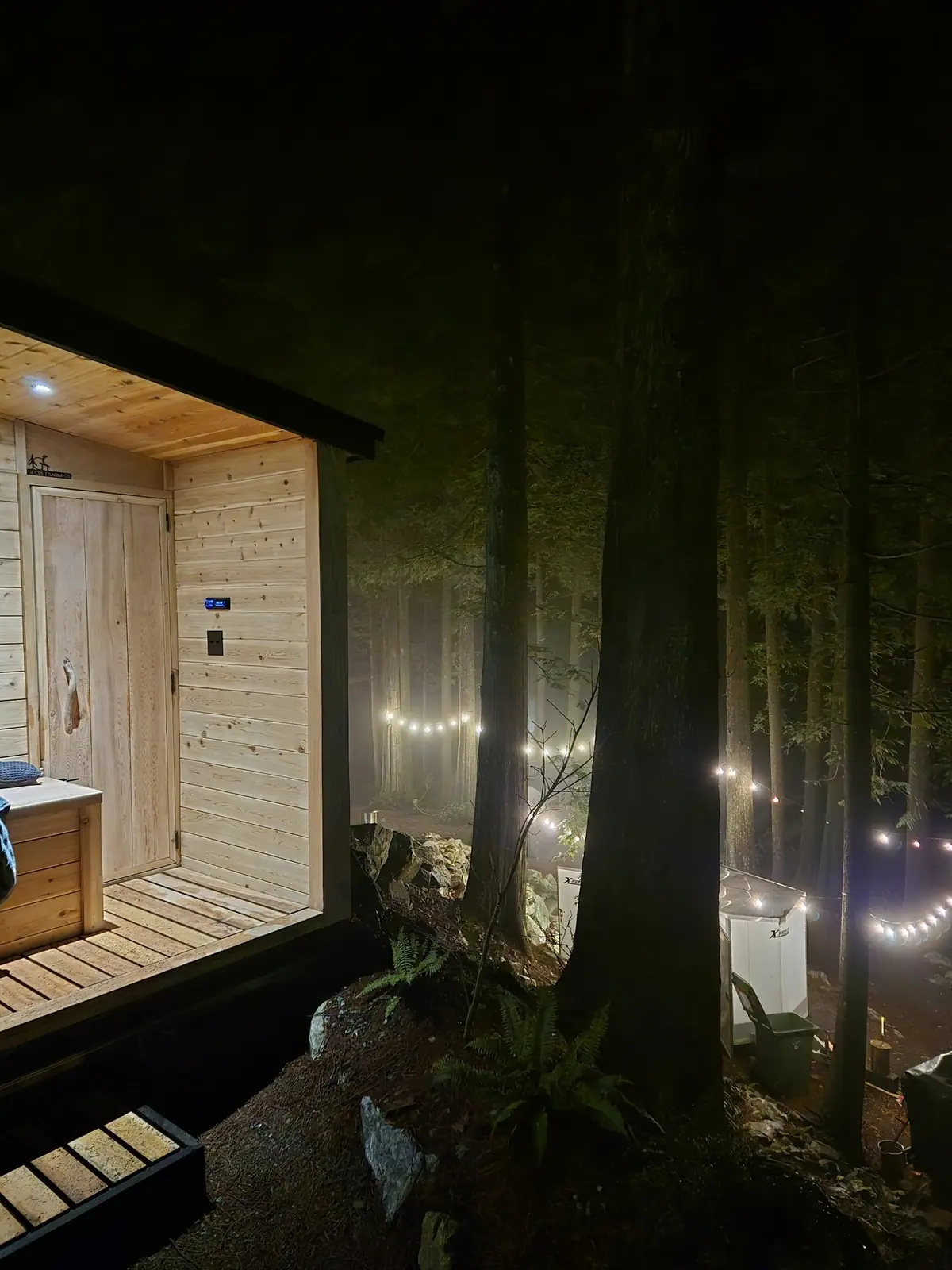 Finnish sauna at dusk with warm interior lighting
