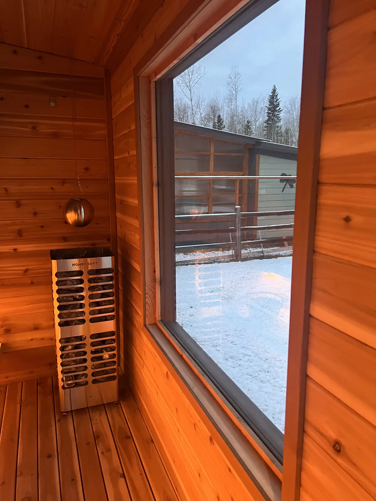 Traditional wood-fired sauna heater with hot stones for authentic loyly